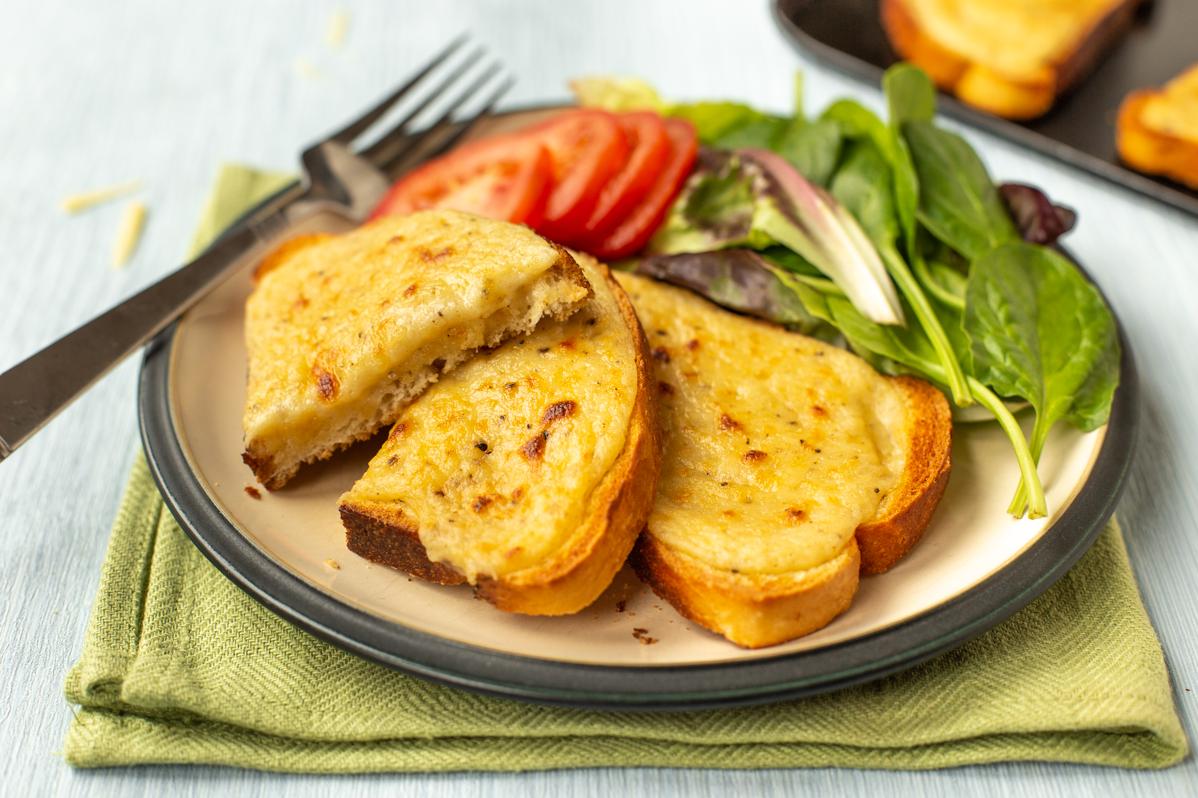  A perfectly toasted slice of bread topped with a generous helping of the cheesy sauce.