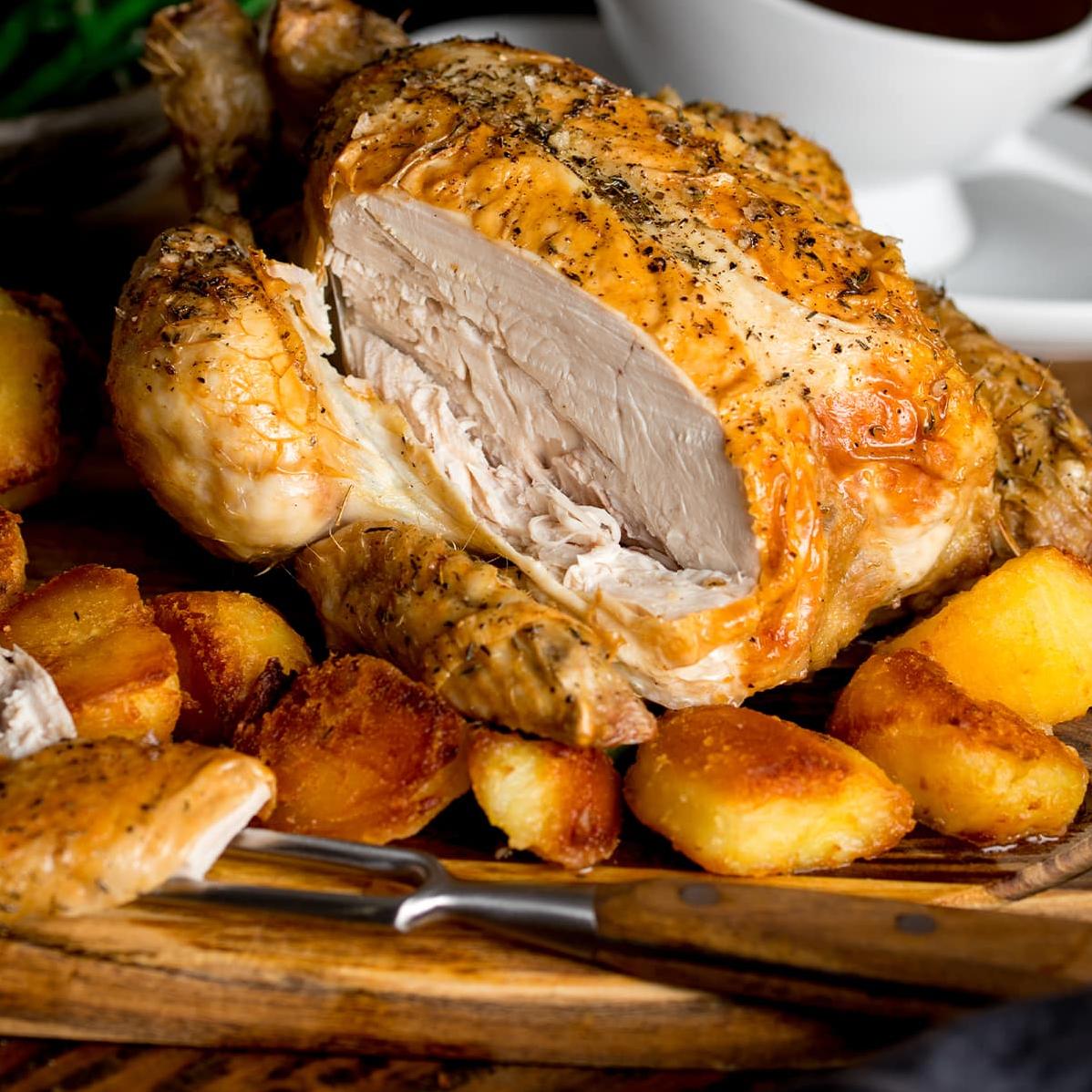 Perfectly roasted chicken infused with flavorful herbs and spices, served with homemade gravy on the side