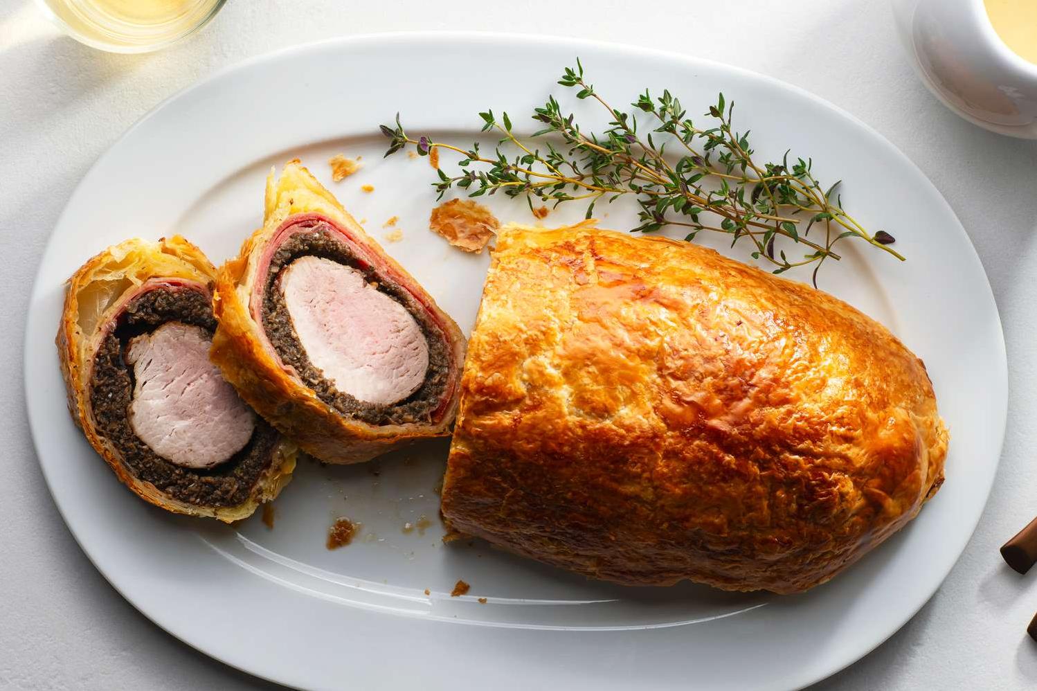  The crispy golden brown exterior of the Pork Wellington is a sight to behold.