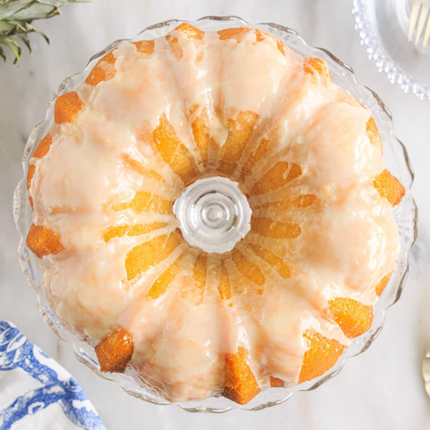  The golden brown crust of this cake pairs perfectly with the vibrant colors of pineapples and oranges.